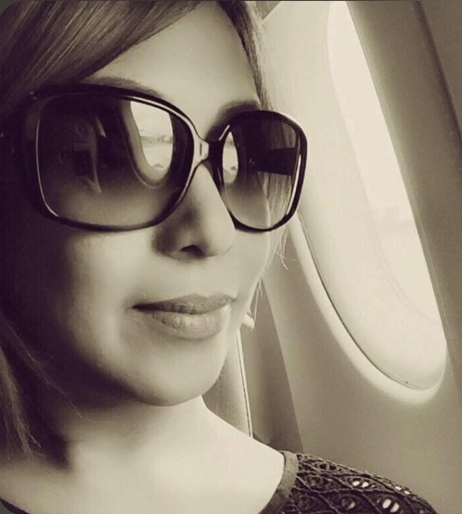 Madz Gerardo, Lead Travel Advisor at Madz Travel, photographed by an aircraft window